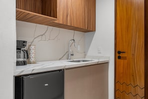 A compact kitchen with a built-in dishwasher, a coffee maker, and a sink. - 3BR condo near the ocean in Bucerías with pool, WiFi & full kitchen (Bucerias)
