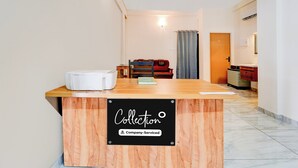 A reception desk with a sign indicating 'Collection Company-Serviced.' - Collection O Calicut Near Calicut (Kozhikode)