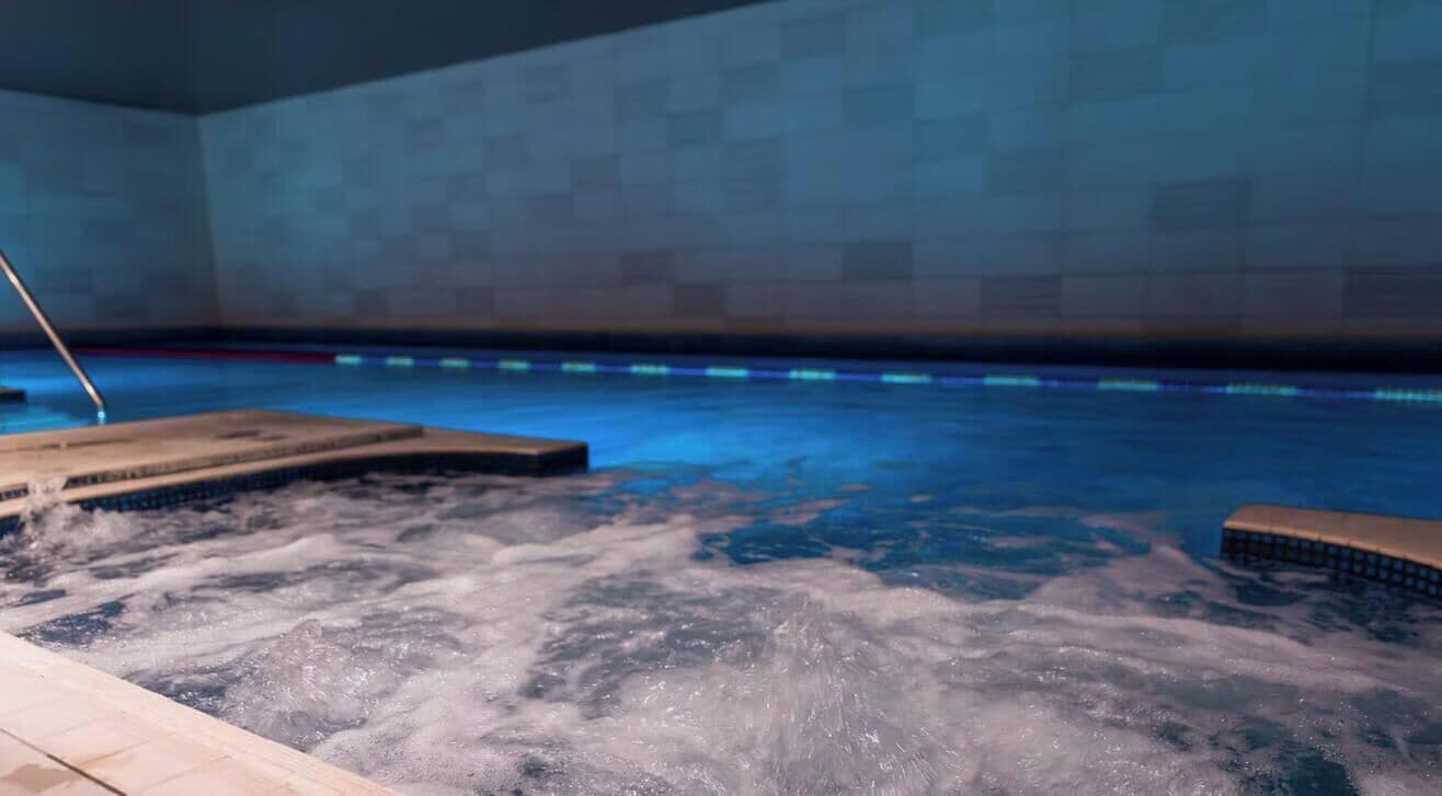 A hot tub with water jets in a tiled room.