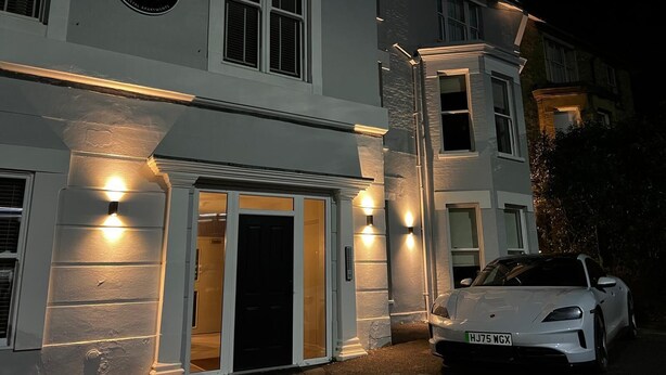 A white building with a sign reading 'PELICAN HOUSE' and a white car parked in front. - Pelican House No.6 | Luxury Apartment | Walk to the Beach | Bournemouth Centre (Bournemouth, Christchurch and Poole)