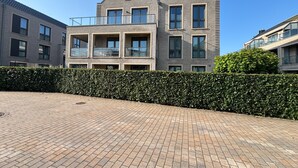A modern two-story residential building with a brick facade, multiple windows, and balconies. - Apartment "Strandzeit" in Nordsee Park Dangast with Balcony and Private Sauna (Varel)