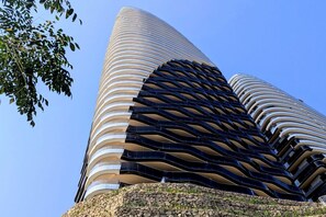 A modern building with a curved facade and a series of balconies. - SUNSET SAILORS prestige apartment (Benidorm)