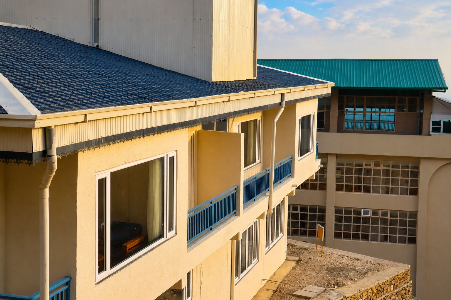 A multi-story building with balconies and large windows.