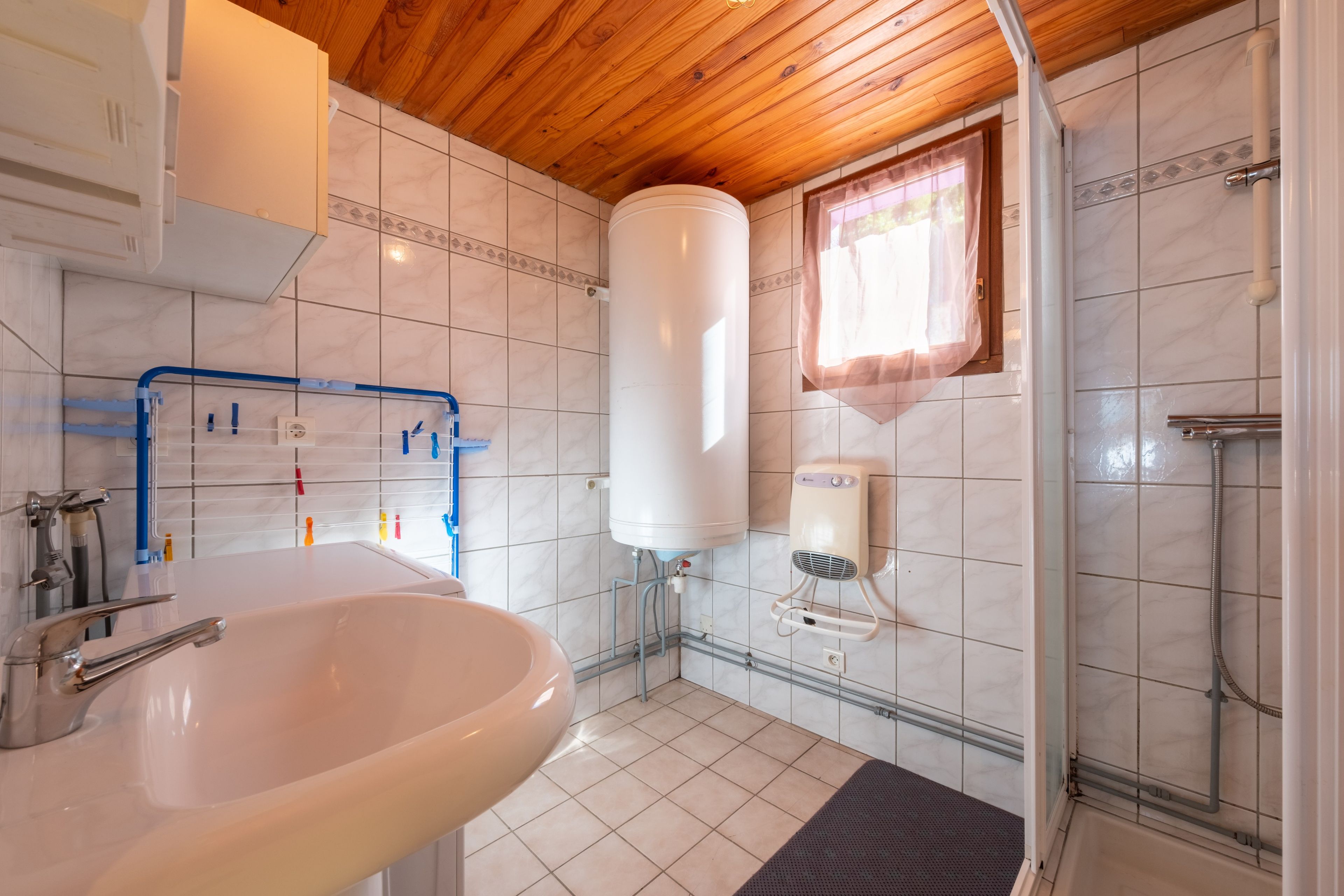 A bathroom with a sink, a shower, and a toilet.