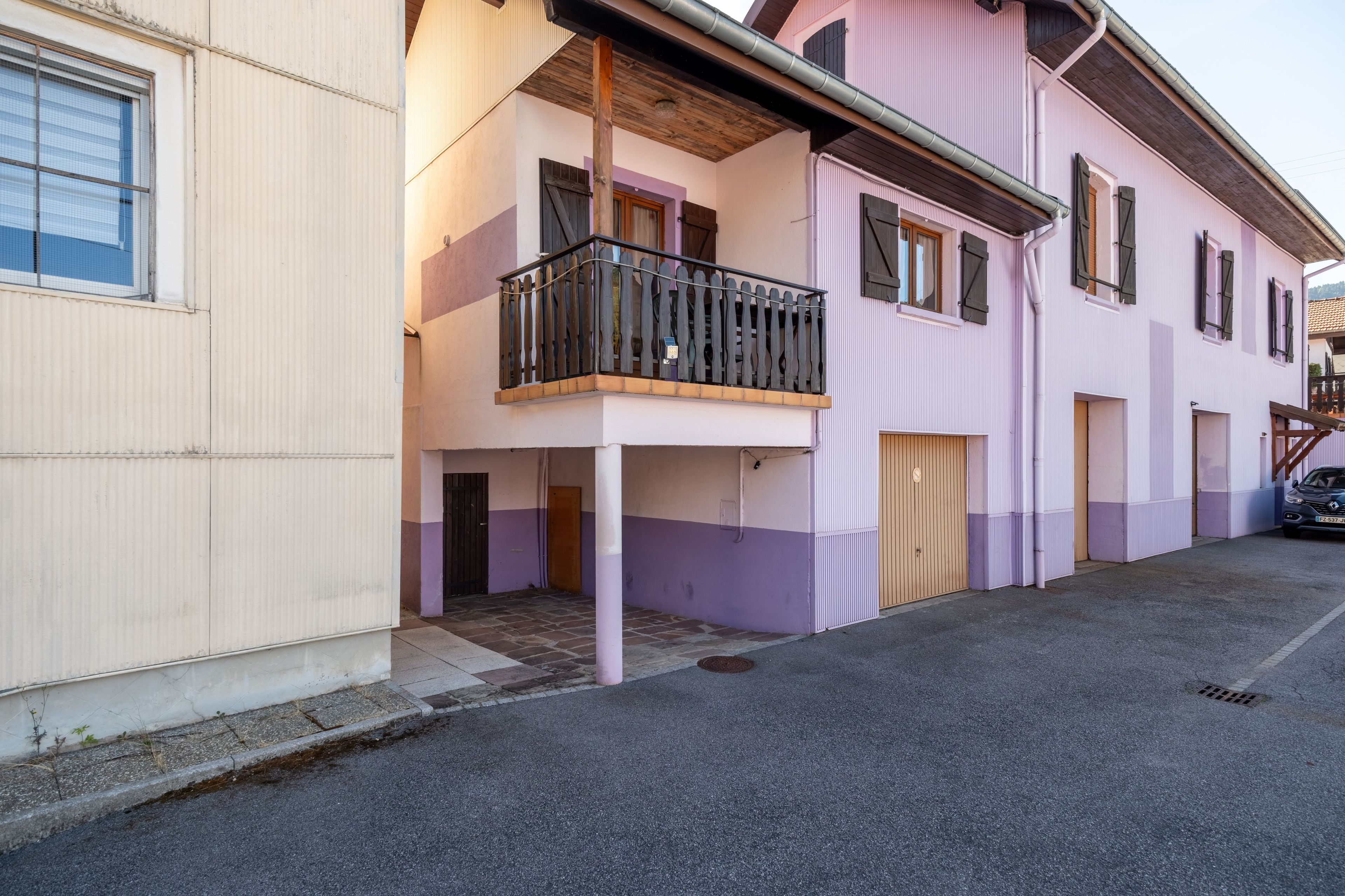 A two-story building with a balcony on the upper floor.