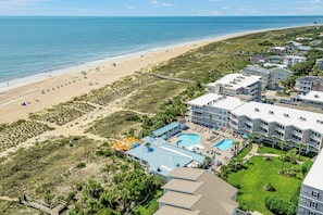 A coastal hotel with a beach view, a swimming pool, and multiple guest rooms. - Unobstructed Ocean Views Direct Beach/Pool Access + Parking by Tybee Cottages (Tybee Island)