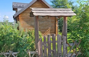 A rustic wooden cabin with a sloped roof and a wooden porch. - Cosy Cottage — Agrotourism Jizerska Zagroda (Gierczyn)