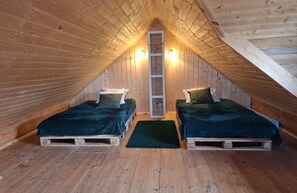 A small attic bedroom with two beds, wooden walls, and a ladder. - Cosy Cottage — Agrotourism Jizerska Zagroda (Gierczyn)