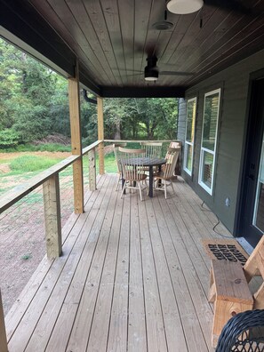 A wooden deck with a table and chairs, overlooking a grassy area. - New Pondside Retreat Near Lake Ouachita (Royal)