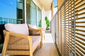 A balcony with wicker furniture and potted plants. - Unic Serenity Apartment Javea (Javea)