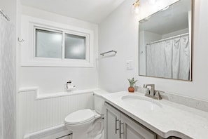Bathroom - Renovated split-level with killer Lambeau Field views. Super short walk to games & Titletown District. Fully fenced yard. 3 bedrooms + bath upstairs, kitchen/dining main, living room lower, bedroom + bath lowest level. Perfect game-day base! (Green Bay)