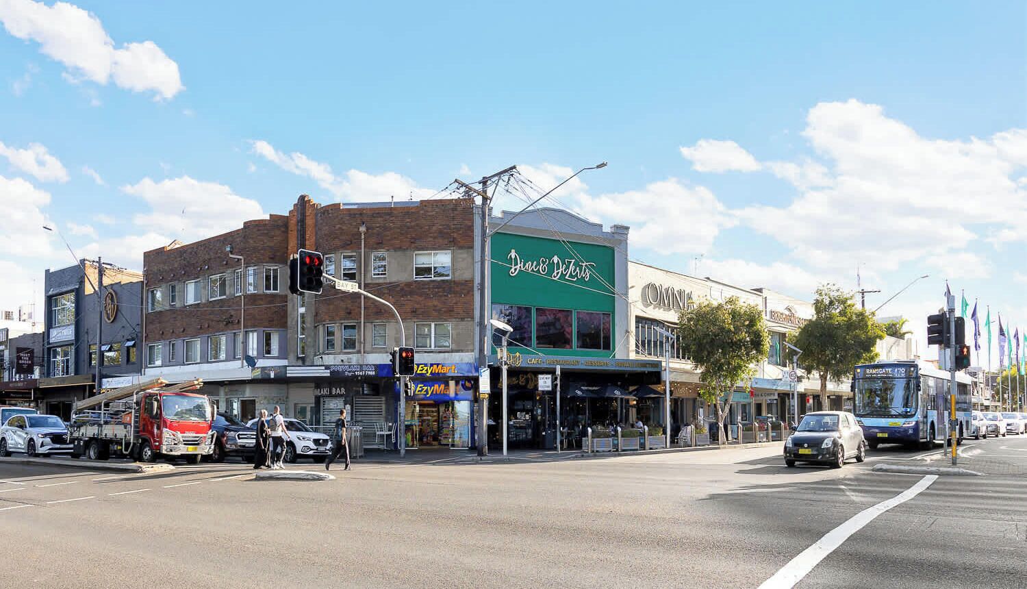 A street view with a building labeled 'Dine & Dine' and a visible 'EZyMart' store.