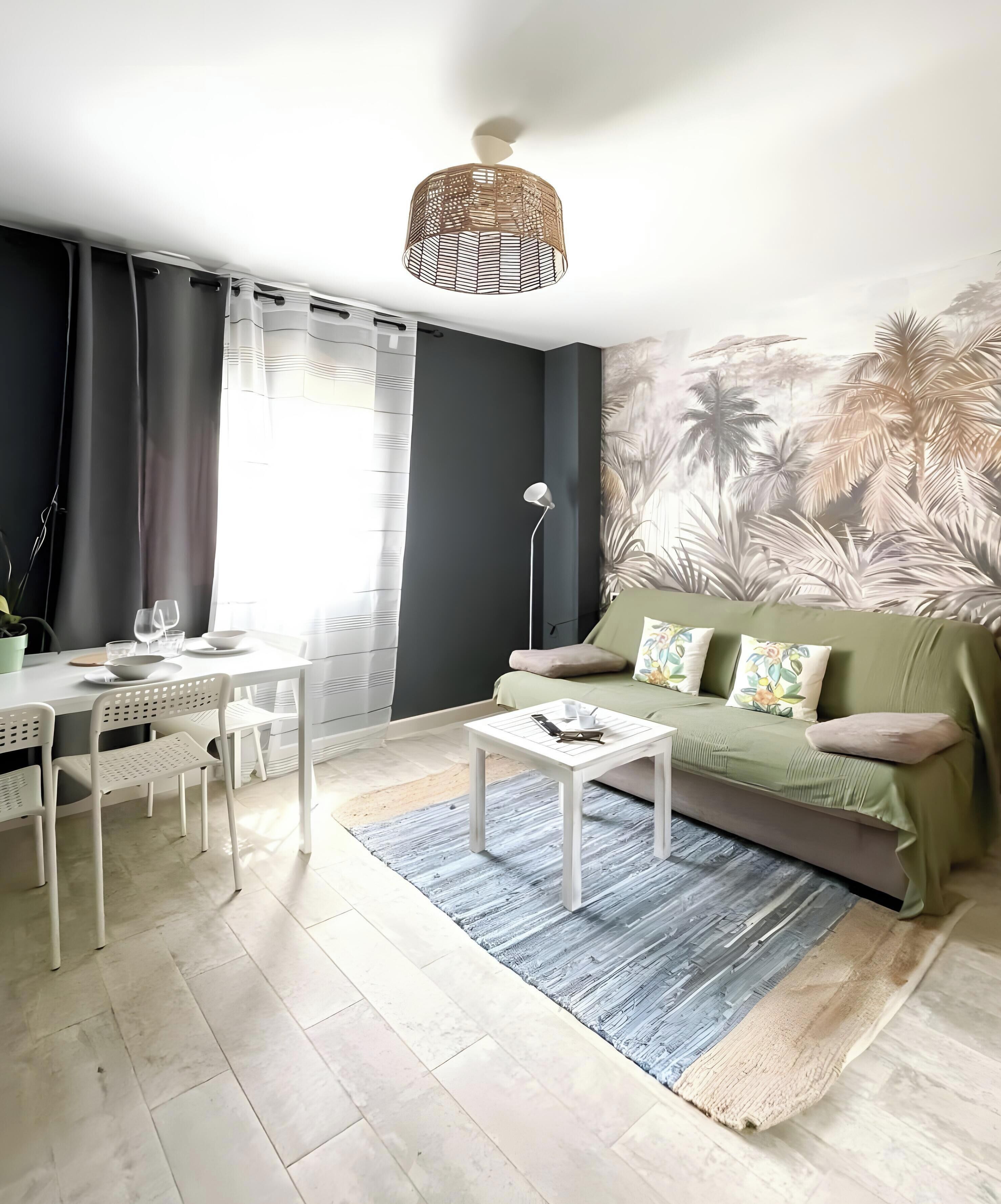 A modern living room with a sofa, coffee table, and dining area.