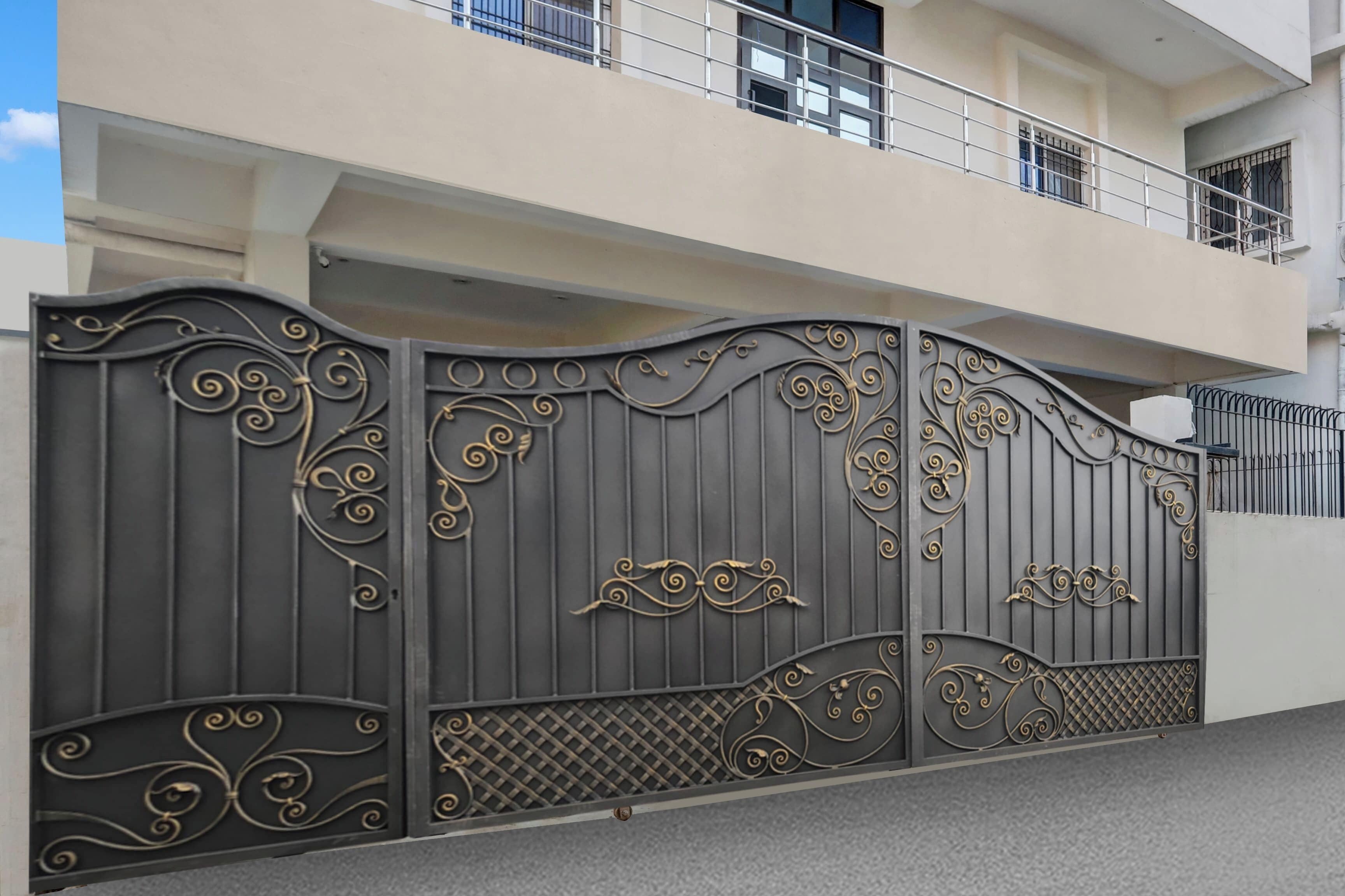 A gated entrance with ornate metalwork and a balcony above.