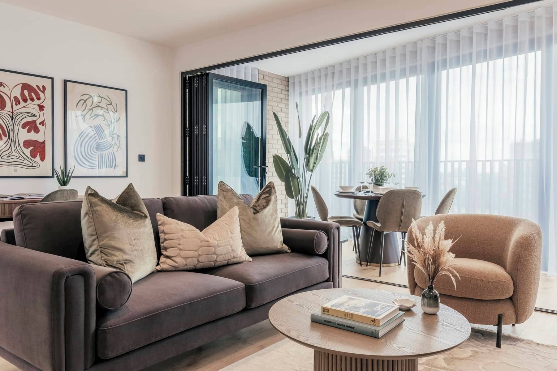 A modern living room with a sofa, armchairs, and a coffee table.