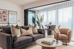 A modern living room with a sofa, armchairs, and a coffee table. - Urban Rest Albert Embankment (London)