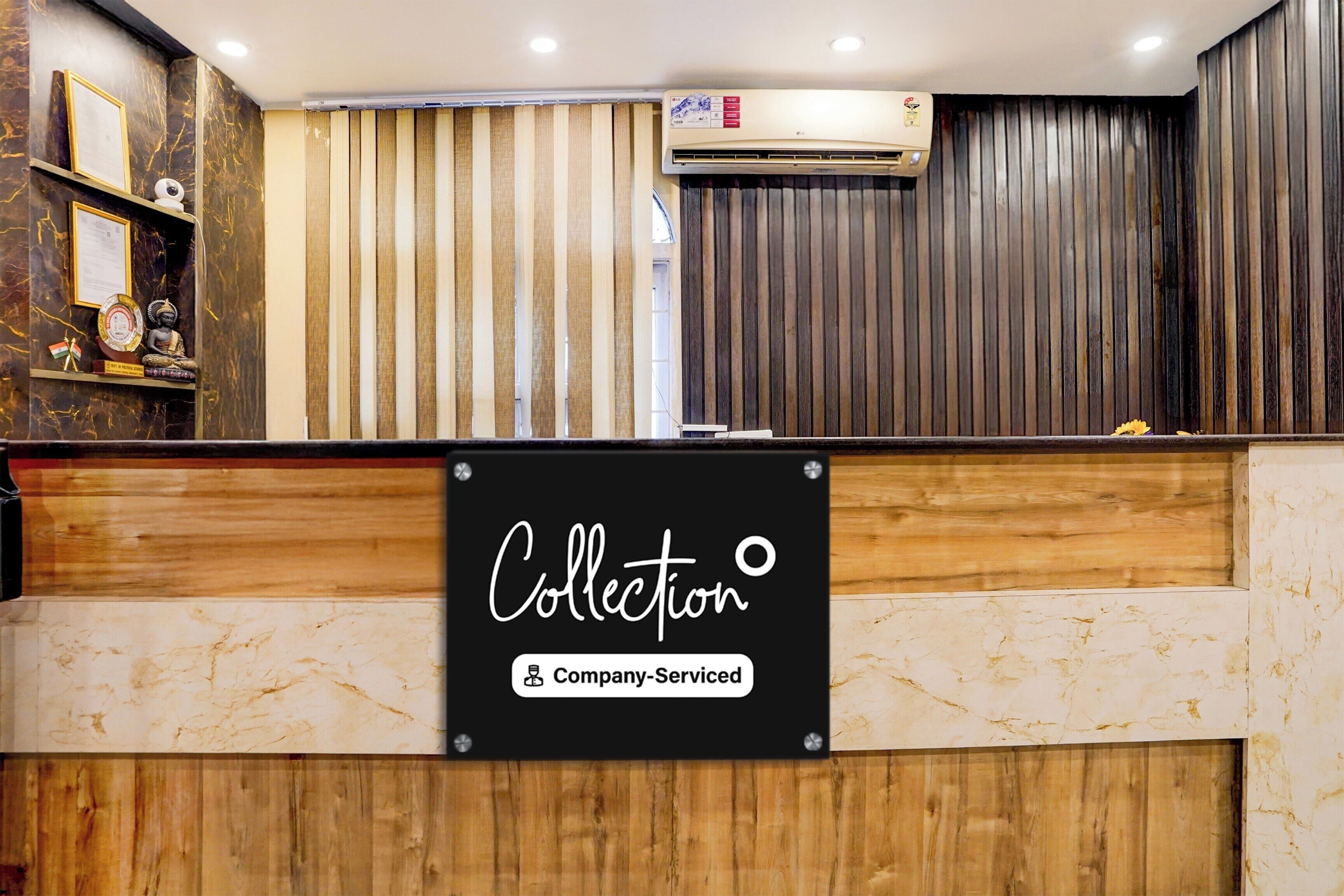 A reception desk with a sign indicating 'Collection' and 'Company-Served'.