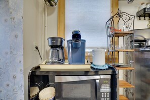 A kitchen with a coffee maker, a microwave, and a coffee pot on the counter. - Walk to Main St Stroudsburg! Historic Dtwn Home (Stroudsburg)