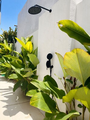 A pathway lined with large green plants and a wall-mounted showerhead. - 2BR Private Pool Villa Walk to Pererenan Beach and Cafes (Mengwi)