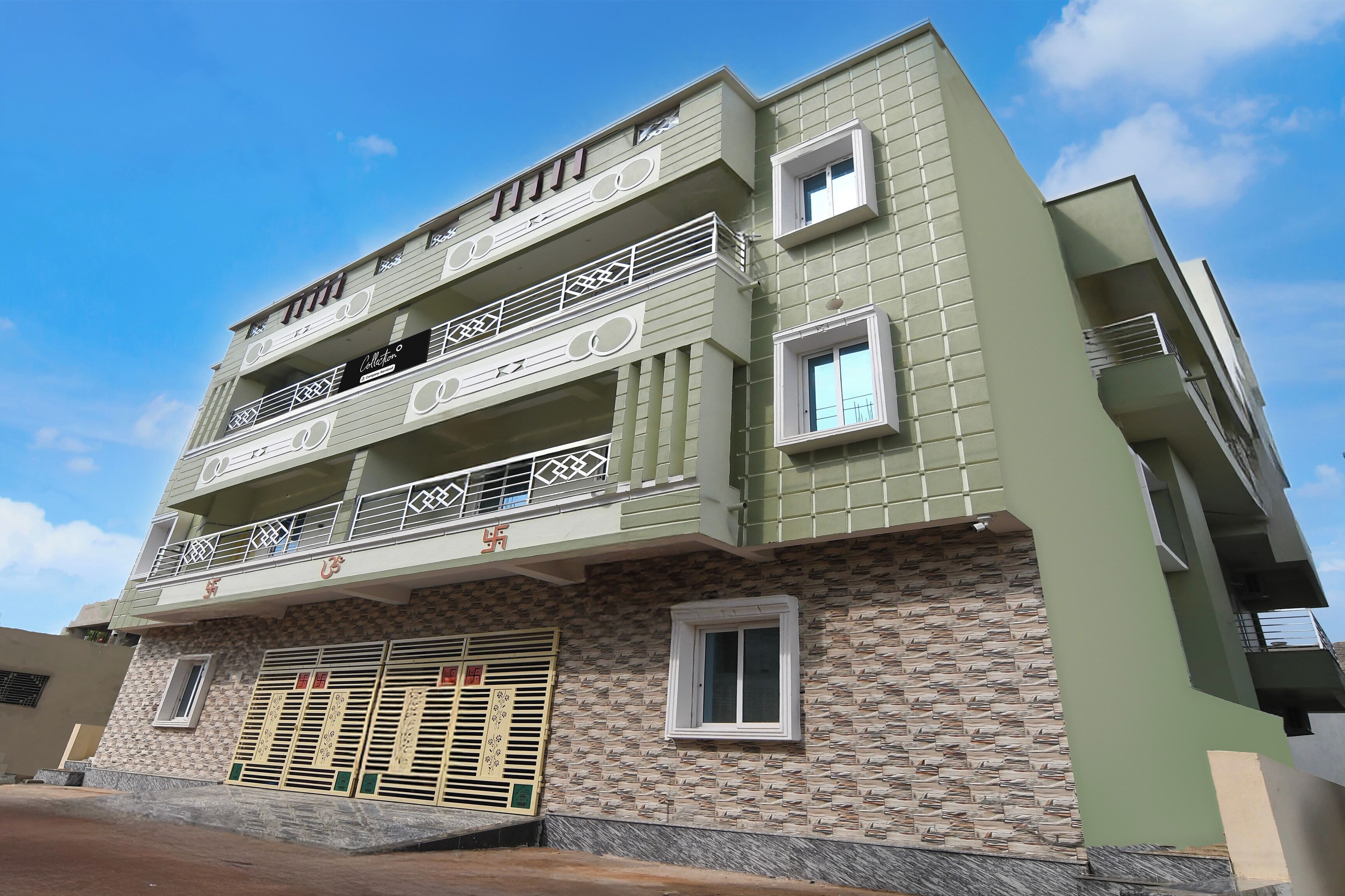 A multi-story building with balconies and a garage.