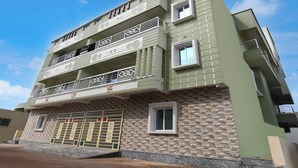 A multi-story building with balconies and a garage. - Collection O Shree Jagannatha Temple (Puri)