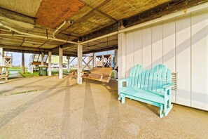An outdoor covered area with a concrete floor, wooden benches, and a turquoise bench. - 3 BR, 2 BA Pet-friendly Fort Morgan home with water views! (Gulf Shores)