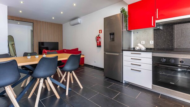 A modern kitchen with a stainless steel refrigerator, a built-in oven, and a coffee machine. - Geneve Old Town T3 Apartment (Albufeira)