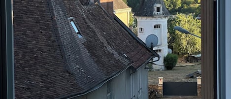 A view of buildings with steep roofs and a church with a pointed steeple.
