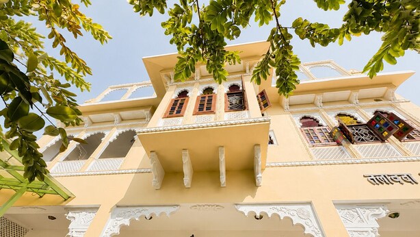 A traditional building with ornate balconies and detailed architectural design. - 3BHK Homestay in Udaipur, Lake View Private Terrace & Parking (Udaipur)