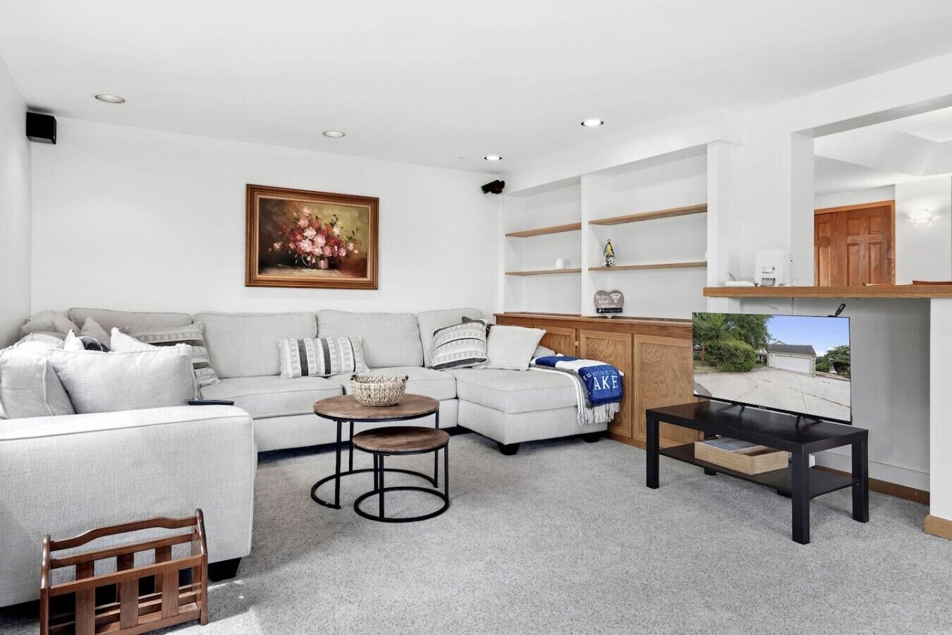 A modern living room with a sofa, coffee table, and TV stand.