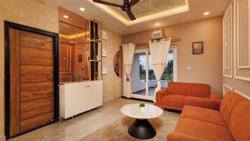 A modern living room with a sofa, a coffee table, and a ceiling fan.