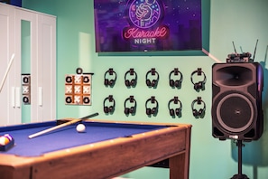 A pool table, a karaoke sign, and multiple headphones on the wall. - Heated Pool • Hot Tub • Pickleball • Game Room (Seminole)