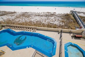 A pool area with a view of a beach and a boardwalk. - Phoenix Iii 3036 2 Bedroom Condo (Orange Beach)