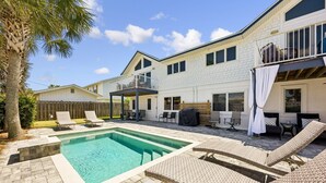 A two-story house with a swimming pool, outdoor seating, and a wooden deck. - 733a And B Tarpon Avenue 6 Bedroom Home (Fernandina Beach)