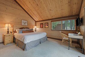 A bedroom with a bed, bedside tables, lamps, a desk, and a chair. - 16 Pole House 2 Bedroom Home (Bend)
