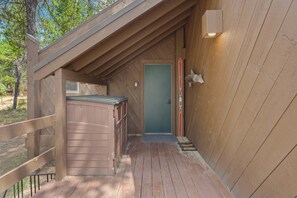 A wooden deck leading to a door with a small porch area. - 16 Pole House 2 Bedroom Home (Bend)