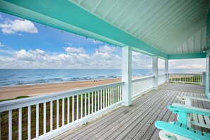 A wooden deck with a view of the beach and ocean. - Gabriels Landing 5 Bedroom Home (Port Bolivar)