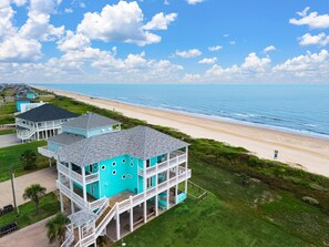 A two-story beachfront property with a balcony overlooking the beach. - Gabriels Landing 5 Bedroom Home (Port Bolivar)