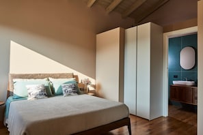 A bedroom with a bed, bedside table, and a wardrobe. - Apartment 'Ulivo' with Shared Pool, Wi-Fi and Air Conditioning (Prignano sulla Secchia)