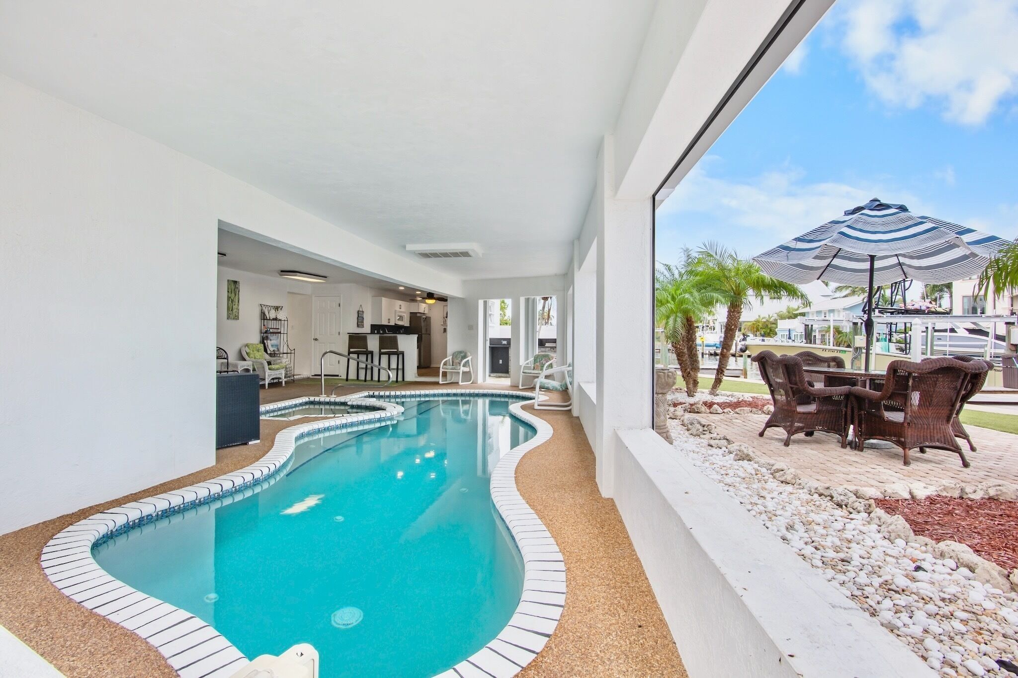 An indoor swimming pool with a view of the outside.