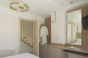 A modern bathroom with a large mirror, a towel rack, and a wooden vanity. - Vitsila Villa II, Design, Sea Views & Family Fun (Rethymno)