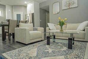 A modern living room with a sofa, armchairs, a glass coffee table, and a patterned rug. - Quiet neighbourhoo
Family friendly
Edmonton Expo Centre
Convenient & comfortable (Edmonton)