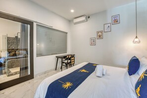 A hotel room with a bed, a desk, and a large window. - Shala Suites Bali - Pererenan (Mengwi)