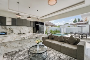 A modern kitchen with marble countertops and a built-in oven. - Shala Suites Bali - Pererenan (Mengwi)