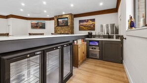 A kitchen with a stone backsplash, a built-in oven, and a coffee machine.