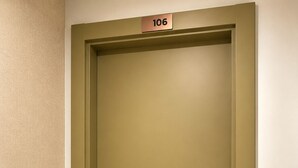 A closed door with a number plate indicating room 106, a modern door handle, and a textured wall. - Luxury Cubelles Aparthotel (Cubelles)