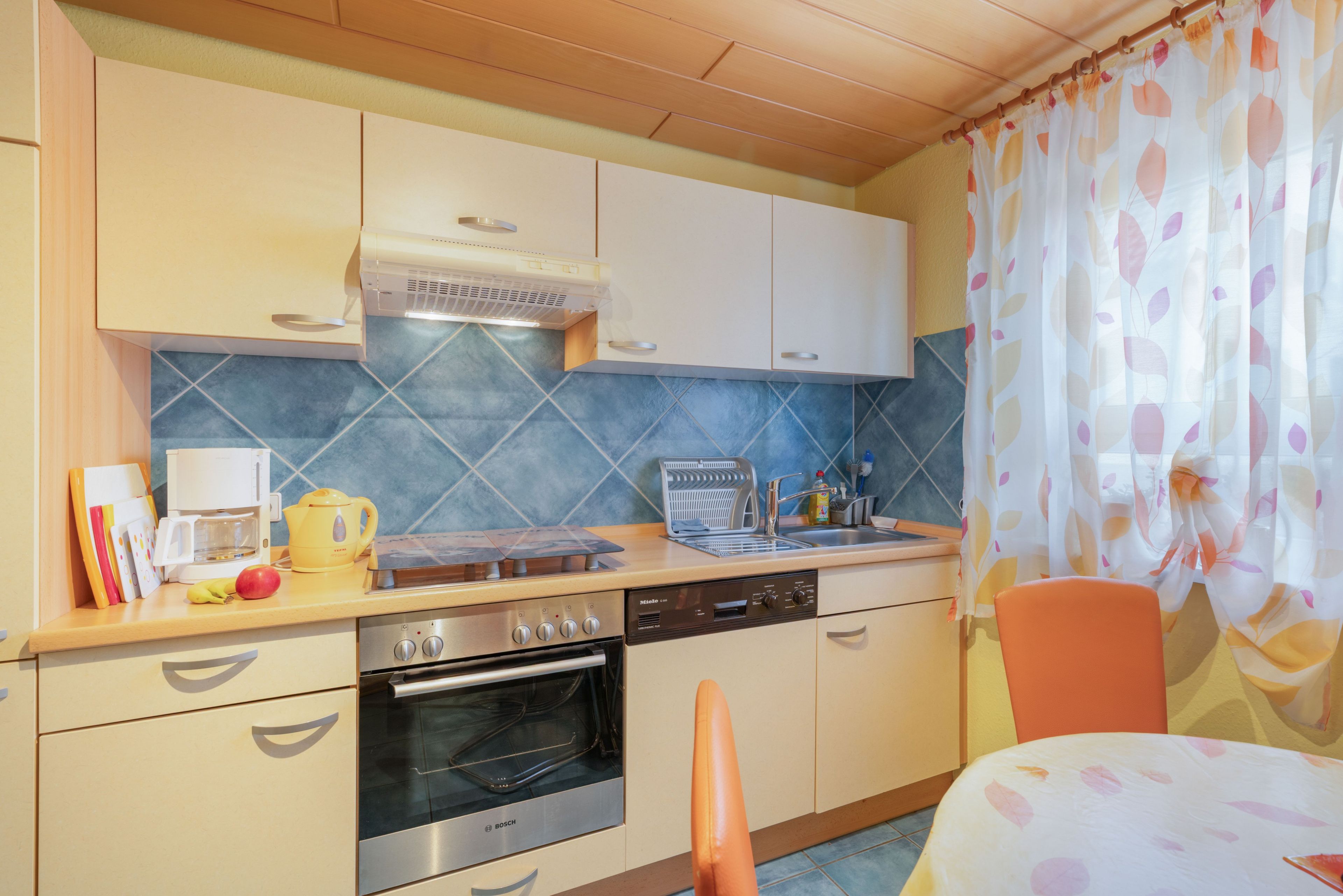 A compact kitchen with a microwave, stove, oven, and a sink.