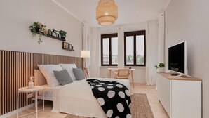 A bedroom with a bed, bedside table, lamp, TV, and a window with a view. - Saniertes Altbauzimmer an der Karlsaue (Kassel)