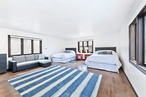 A modern hotel room with a sofa, two beds, a desk, and a large window. - Stunning Sunset Views,Great for Families W Parking! (Newport Beach)
