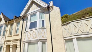 A building with a bay window and a decorative facade.